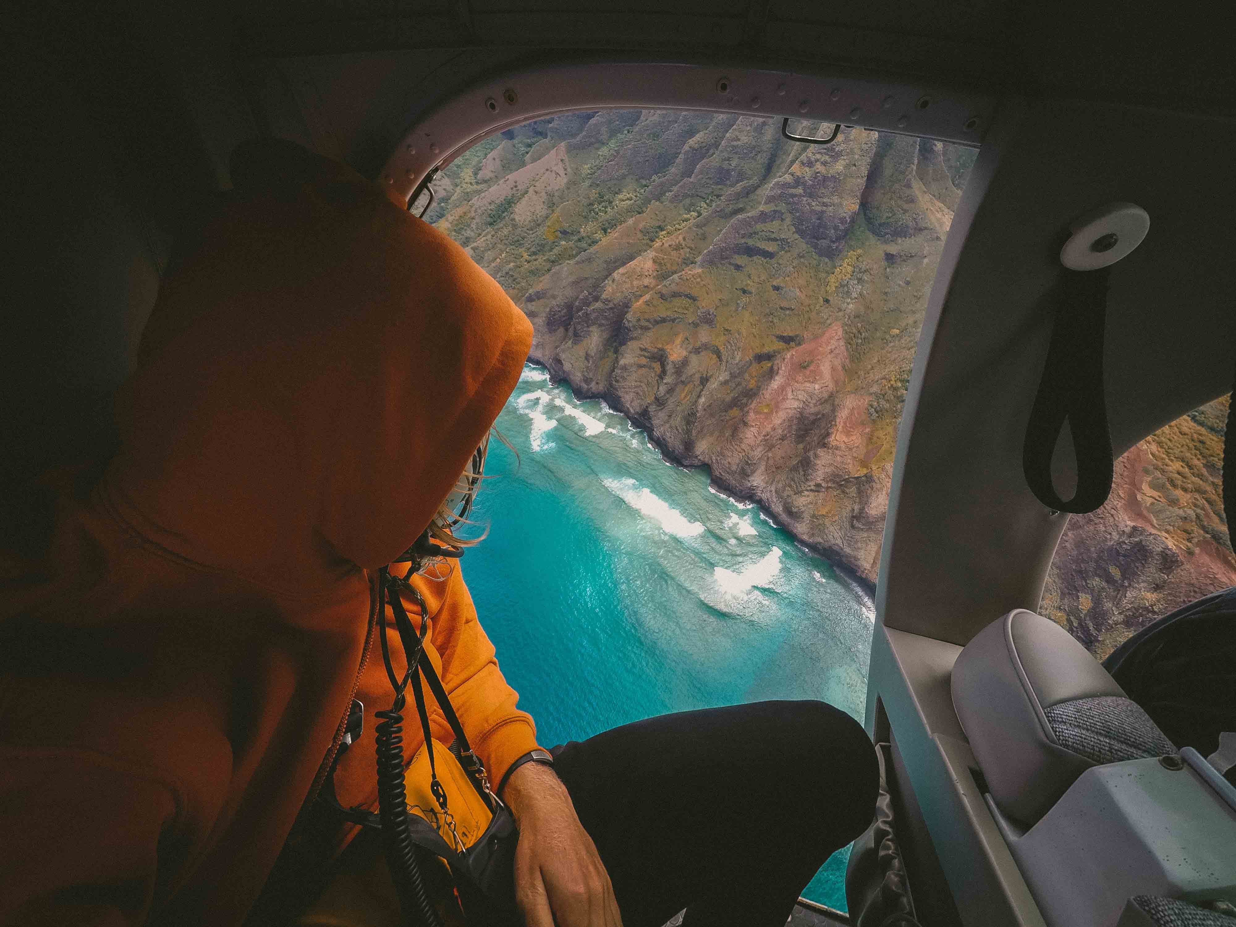 person looking down from helicoptor to beach